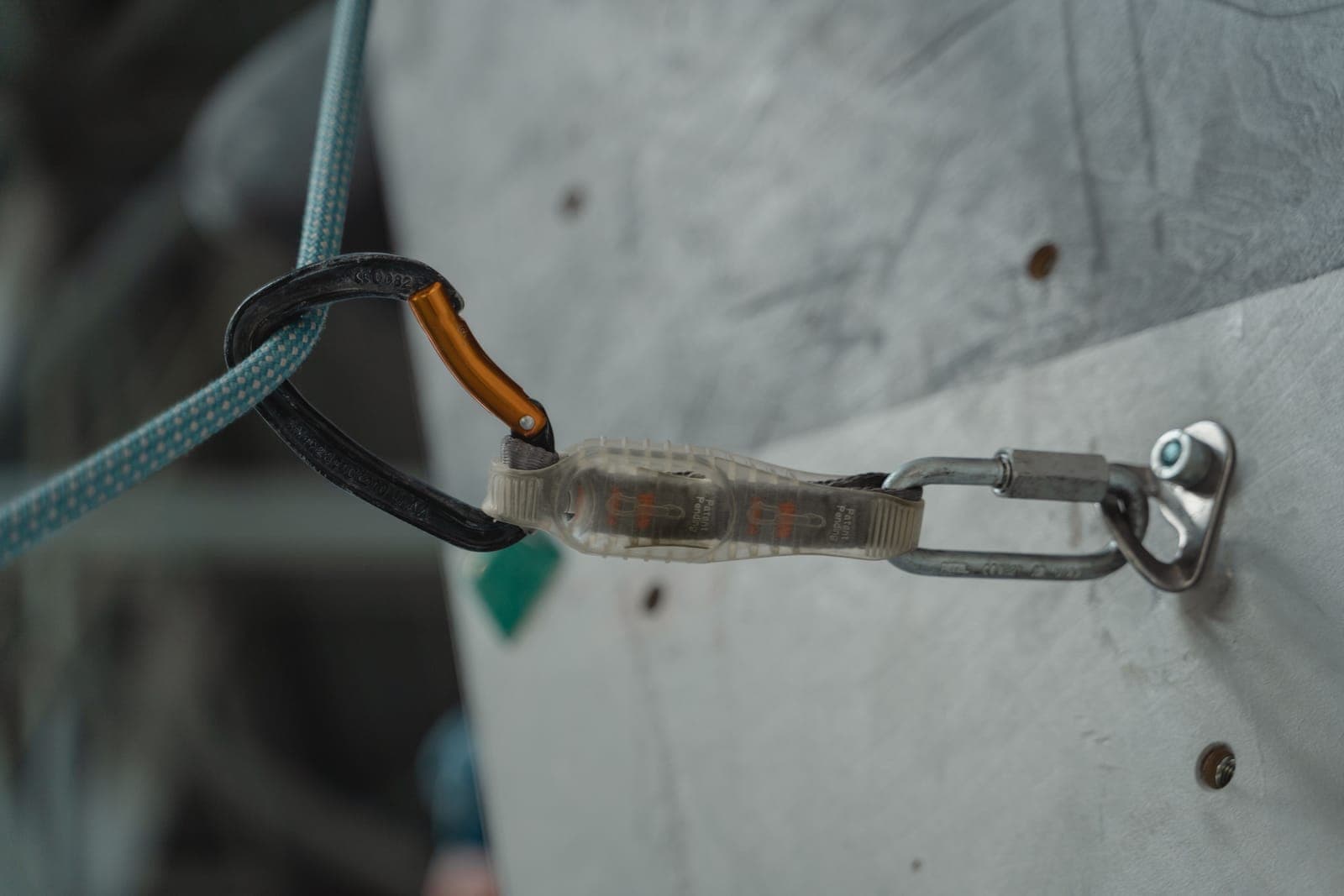 Carabiners, rope and webbing laid out on a wooden surface