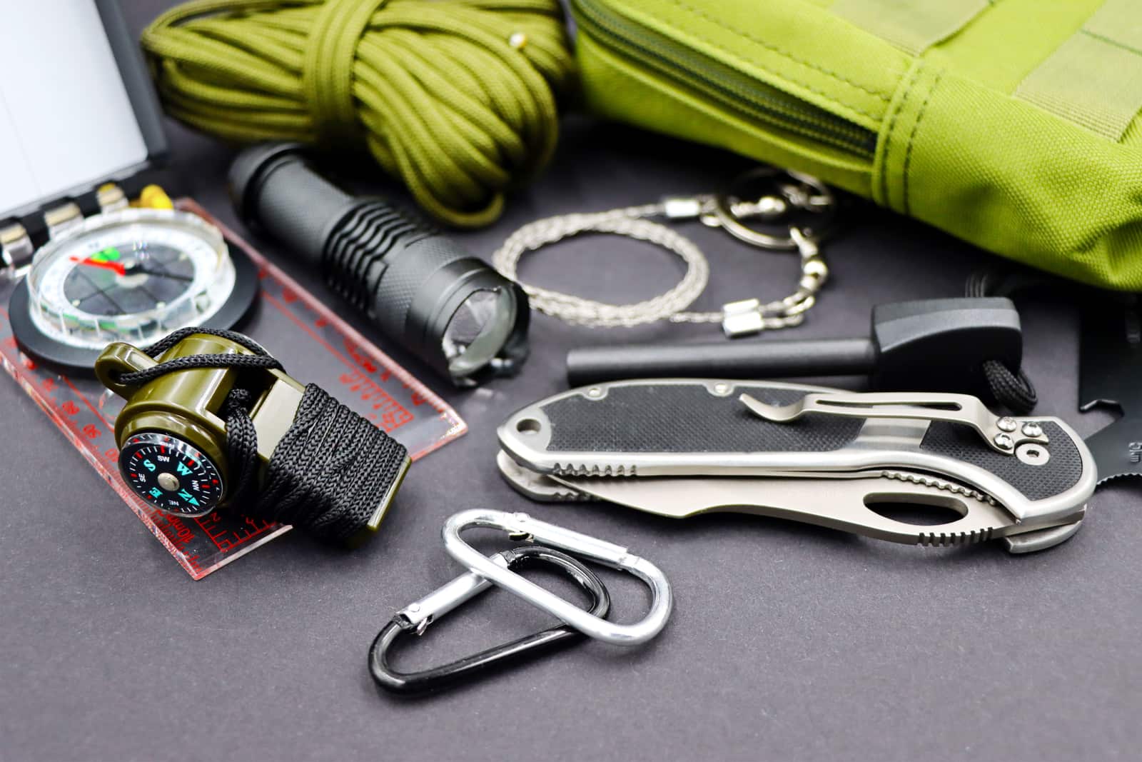 Camping straps, carabiners and cord laid out on a surface
